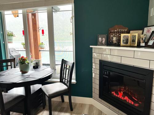 315 - 5570 Broadwater Rd, Castlegar, BC - Indoor Photo Showing Dining Room With Fireplace