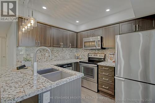 711 - 138 Widdicombe Hill Boulevard, Toronto, ON - Indoor Photo Showing Kitchen With Double Sink With Upgraded Kitchen