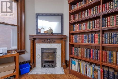Original wood buring fireplace mantel & built in library - 167 10Th Street W, Owen Sound, ON - Indoor With Fireplace