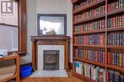Original wood buring fireplace mantel & built in library - 
