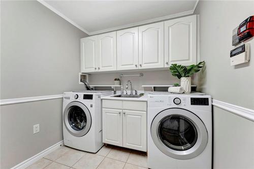 Main Floor Laundry includes entrance to the garage - 40 Dunrobin Drive, Caledonia, ON - Indoor Photo Showing Laundry Room