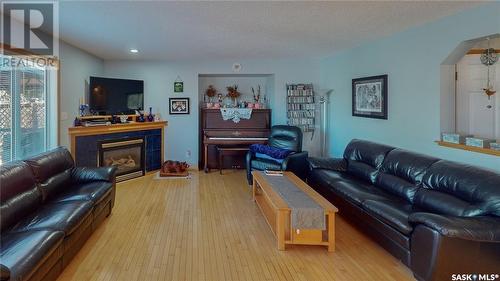 3566 Waddell Crescent E, Regina, SK - Indoor Photo Showing Living Room With Fireplace