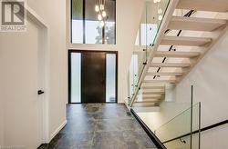 The two-story foyer is a stunning architectural feature which makes a bold statement about this home's style and refinement. - 