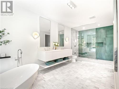 Spa-like ensuite featuring marble tile flooirng, double sinks, a jetted shower, and a luxurious soaker tub, even the most discerning buyer is sure to be impressed. - 261 Whitmore Drive, Waterloo, ON - Indoor Photo Showing Bathroom