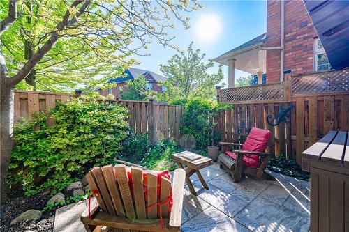 Enjoy this low maintenance back yard with mature trees and landscaped shrubs as your backdrop - 5255 Dryden Avenue, Burlington, ON - Outdoor With Deck Patio Veranda With Exterior