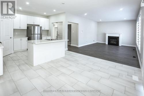 84 Alcorn Drive, Kawartha Lakes, ON - Indoor Photo Showing Kitchen With Fireplace