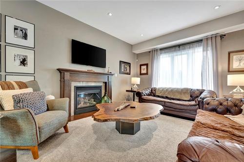 gas fp for winter warmth - 920 Stone Church Road E, Hamilton, ON - Indoor Photo Showing Living Room With Fireplace