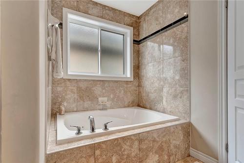 ensuite jetted soaker tub - 920 Stone Church Road E, Hamilton, ON - Indoor Photo Showing Bathroom