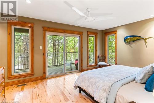 Patio doors from primary bedroom - 61 Fox Trail, Northern Bruce Peninsula, ON - Indoor Photo Showing Bedroom