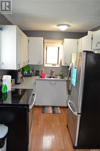 309 1St Avenue W, Kindersley, SK - Indoor Photo Showing Kitchen With Double Sink