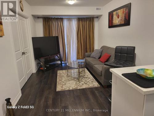 100 - 6705 Cropp Street, Niagara Falls, ON - Indoor Photo Showing Living Room