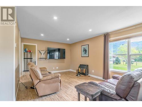 94 Tomkinson Road, Grindrod, BC - Indoor Photo Showing Living Room With Fireplace