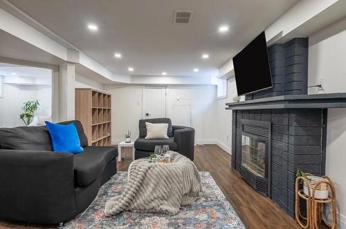 122 Queensdale Avenue E, Hamilton, ON - Indoor Photo Showing Living Room With Fireplace