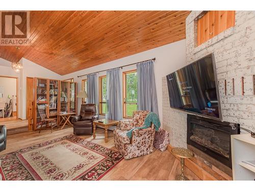 7025 97A Highway, Grindrod, BC - Indoor Photo Showing Living Room With Fireplace