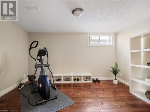 Gym featuring hand-scraped engineered hardwood flooring - 110 Golf Course Road, Woolwich, ON - Indoor Photo Showing Gym Room