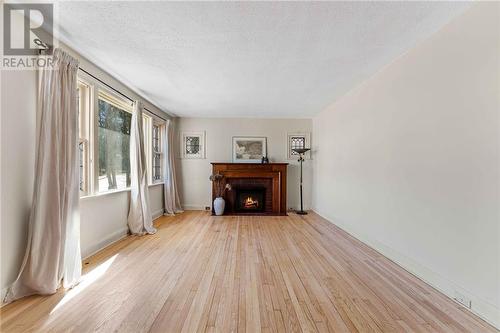 MAIN FLOOR LIVING ROOM - 944 Pembroke Street W, Pembroke, ON - Indoor Photo Showing Living Room With Fireplace