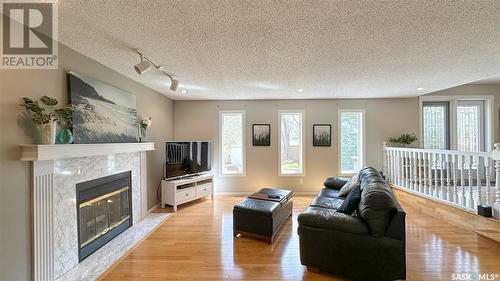 3119 Spicer Place E, Regina, SK - Indoor Photo Showing Living Room With Fireplace