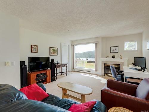 205-6585 Country Rd, Sooke, BC - Indoor Photo Showing Living Room With Fireplace