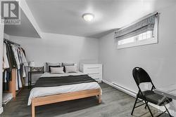 Bedroom 1 - Lower Unit. Disclaimer: Tenant's personal items were digitally removed/modified to showcase the property. - 
