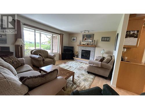 5153 Lakes Road, 108 Mile Ranch, BC - Indoor Photo Showing Living Room With Fireplace