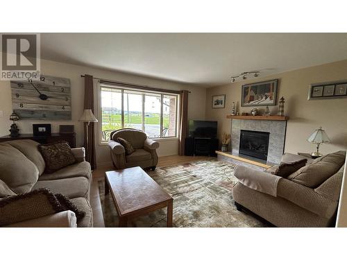 5153 Lakes Road, 108 Mile Ranch, BC - Indoor Photo Showing Living Room With Fireplace