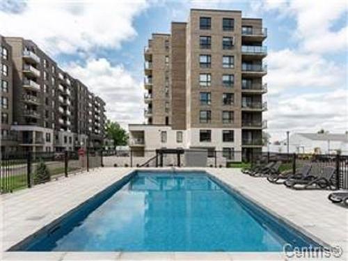 Piscine - 505-1431 Av. De La Gare, Mascouche, QC - Outdoor With In Ground Pool With Facade