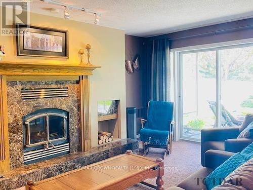 1515 West Street, Hearst, ON - Indoor Photo Showing Living Room With Fireplace