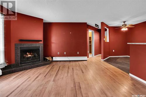 105 2911 Harding Street, Regina, SK - Indoor Photo Showing Other Room With Fireplace