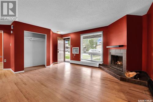 105 2911 Harding Street, Regina, SK - Indoor Photo Showing Living Room With Fireplace