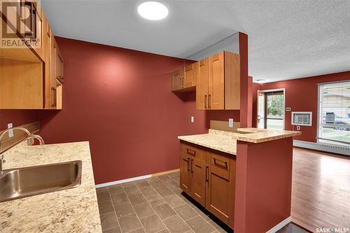 105 2911 Harding Street, Regina, SK - Indoor Photo Showing Kitchen With Fireplace