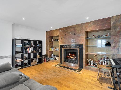 Family room - 410-4475 Boul. St-Jean, Dollard-Des-Ormeaux, QC - Indoor Photo Showing Living Room With Fireplace