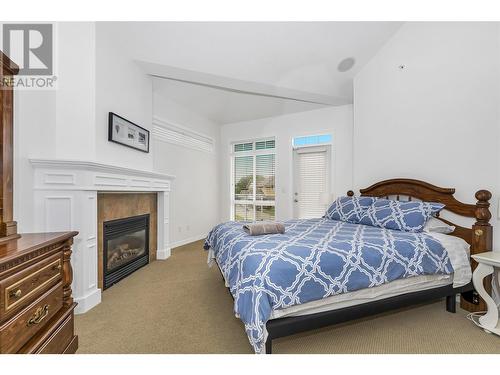 3570 Woodsdale Road Unit# 10, Lake Country, BC - Indoor Photo Showing Bedroom With Fireplace