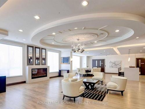 110-7165 Yonge St, Markham, ON - Indoor Photo Showing Living Room With Fireplace