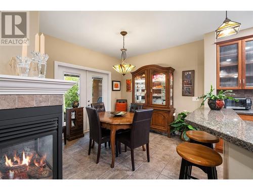 4520 Gallaghers Lookout Unit# 28, Kelowna, BC - Indoor Photo Showing Dining Room With Fireplace