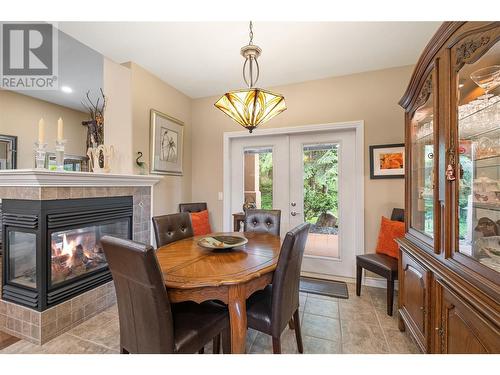 4520 Gallaghers Lookout Unit# 28, Kelowna, BC - Indoor Photo Showing Dining Room With Fireplace