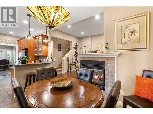 4520 Gallaghers Lookout Unit# 28, Kelowna, BC - Indoor Photo Showing Dining Room With Fireplace