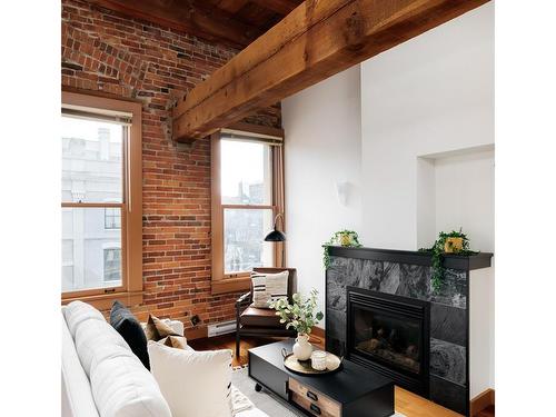 318-599 Pandora Ave, Victoria, BC - Indoor Photo Showing Living Room With Fireplace