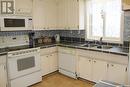 47 Bantry Street, Lanigan, SK  - Indoor Photo Showing Kitchen With Double Sink 