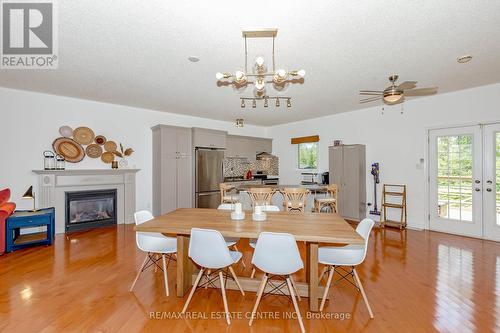 1102 Siesta Drive, Tiny, ON - Indoor Photo Showing Dining Room With Fireplace