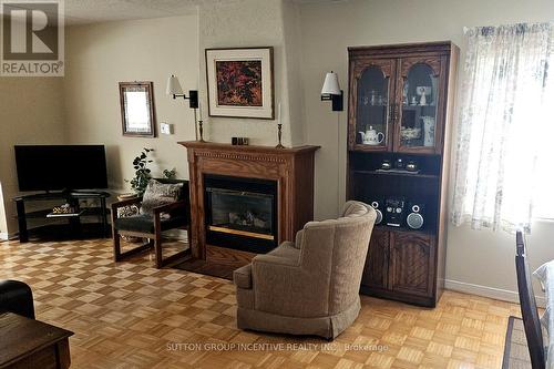 103 - 54 Fittons Road W, Orillia, ON - Indoor Photo Showing Living Room With Fireplace