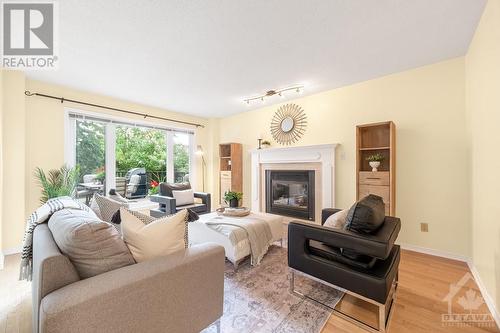 The family room is ideal for cozy winter evenings with a gas fireplace (w/ marble surround). - 21 Keys Way, Ottawa, ON - Indoor Photo Showing Living Room With Fireplace