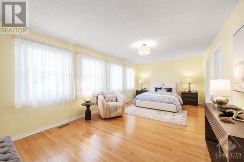 Luxurious primary bedroom with sitting area. - 21 Keys Way, Ottawa, ON - Indoor Photo Showing Bedroom
