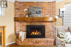 Gather around the propane fireplace built with reclaimed brick from the old Collingwood firehall. - 