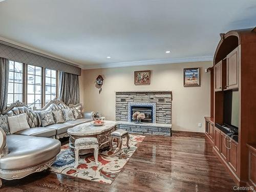 Family room - 10 Rue Du Sauvignon, Kirkland, QC - Indoor Photo Showing Living Room With Fireplace