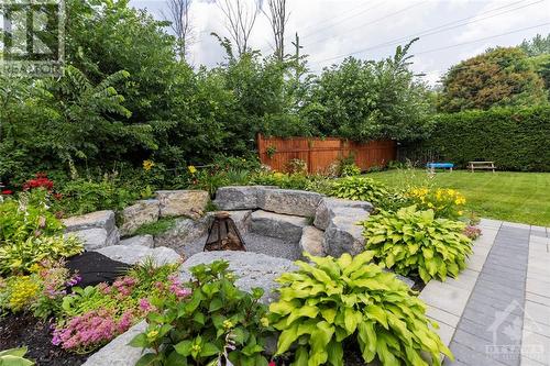 Beautiful sunken armour-stoned fire pit, surrounded by greenery - 87 Ida Street S, Arnprior, ON - Outdoor