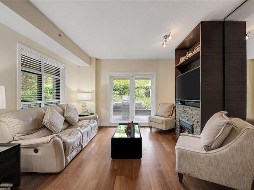 101-1400 Lynburne Pl, Langford, BC - Indoor Photo Showing Living Room With Fireplace