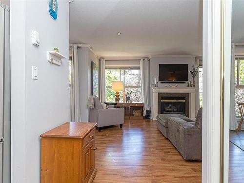 302-1217 Pandora Ave, Victoria, BC - Indoor Photo Showing Living Room With Fireplace