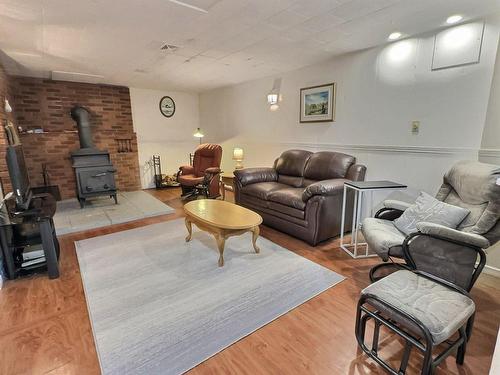 Family room - 23 Rue Champoux, Notre-Dame-Du-Nord, QC - Indoor Photo Showing Living Room With Fireplace