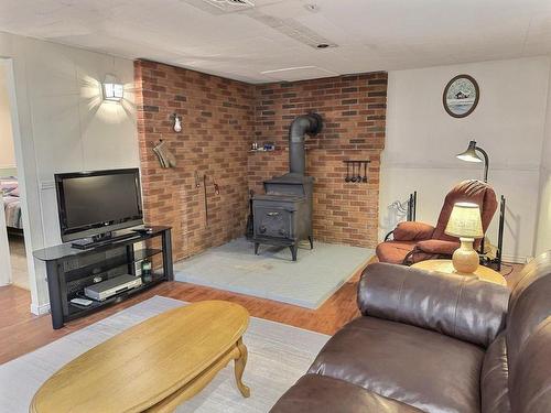 Family room - 23 Rue Champoux, Notre-Dame-Du-Nord, QC - Indoor Photo Showing Living Room With Fireplace