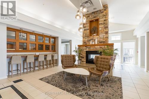 410 - 285 Steamship Bay Road, Gravenhurst, ON - Indoor Photo Showing Living Room With Fireplace